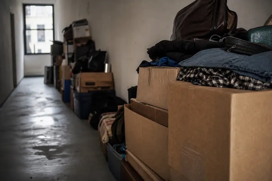 Hallway with progressively stacked boxes and belongings
