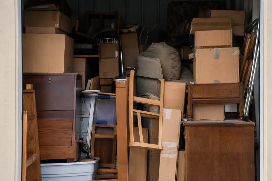 Self-storage unit packed floor to ceiling with boxes and furniture
