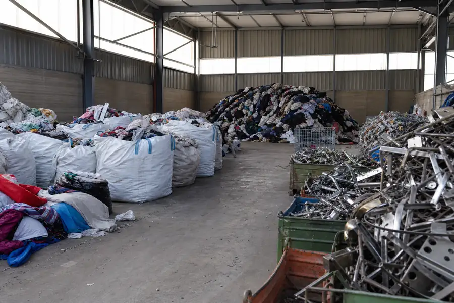 Warehouse with sorted piles of donations, scrap metal and recyclables
